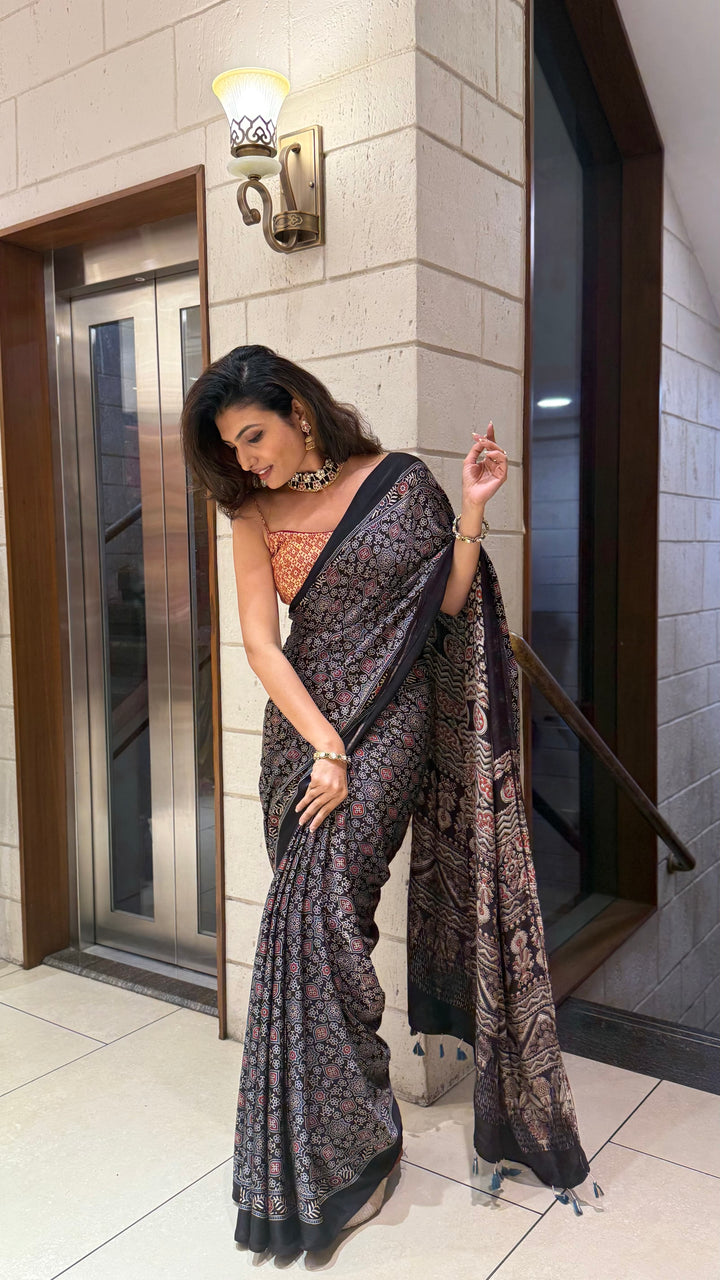 Luxury Black Ajrakh Printed Satin Silk Saree with Copper Blouse & Handcrafted Tassel Pallu