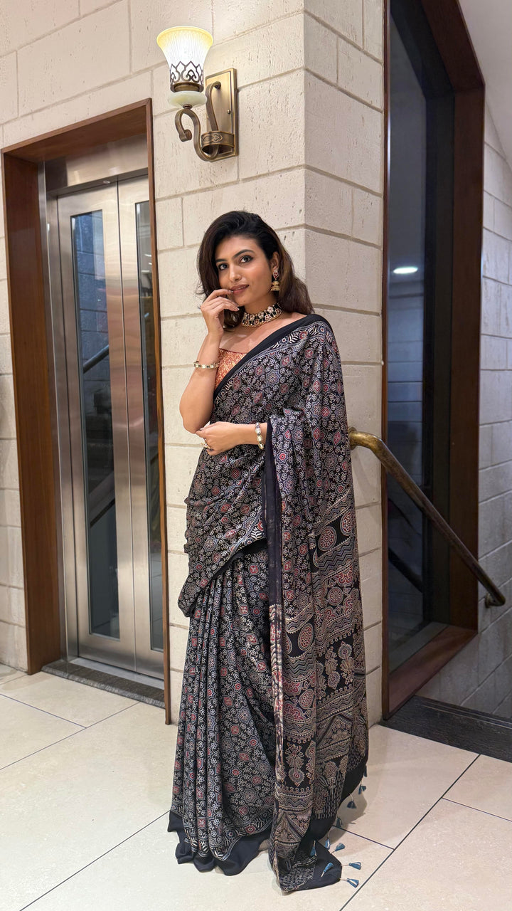 Luxury Black Ajrakh Printed Satin Silk Saree with Copper Blouse & Handcrafted Tassel Pallu