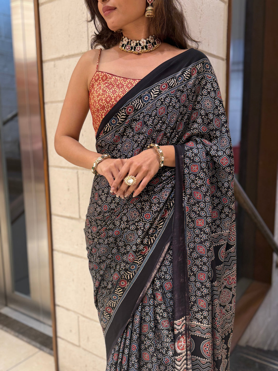 Luxury Black Ajrakh Printed Satin Silk Saree with Copper Blouse & Handcrafted Tassel Pallu