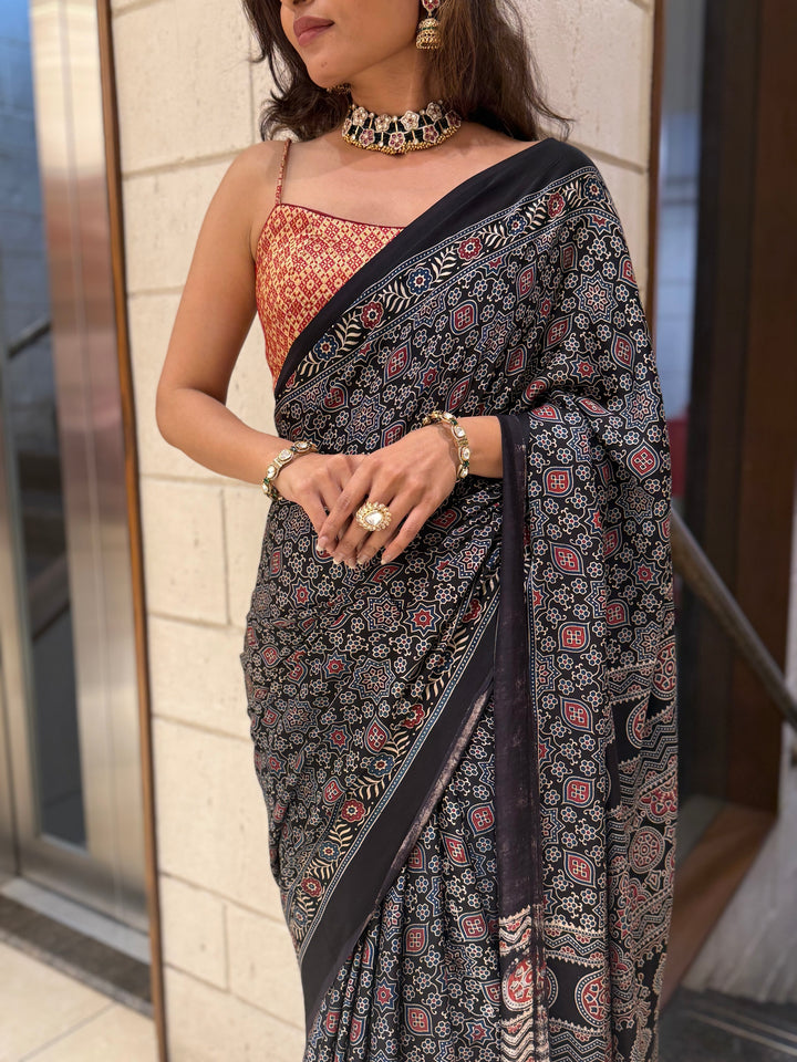 Luxury Black Ajrakh Printed Satin Silk Saree with Copper Blouse & Handcrafted Tassel Pallu