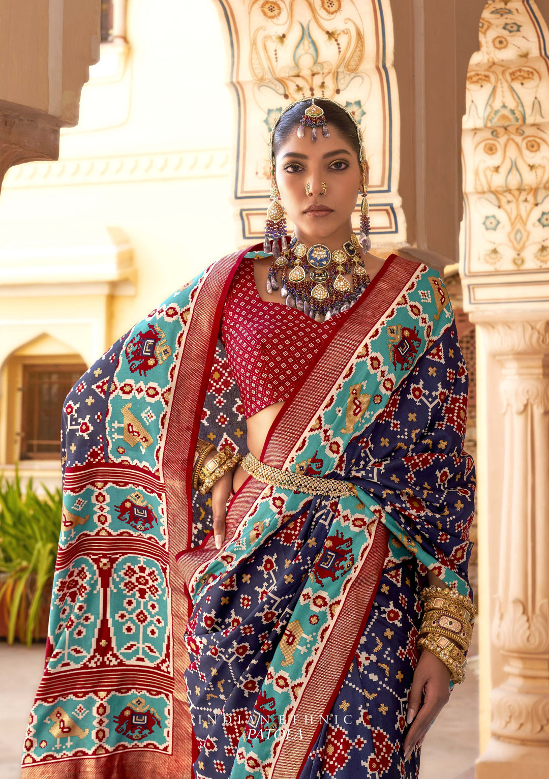 Navy Blue Patola Silk Saree with Intricate Geometric Weaving, Paired with a Matching Red Blouse