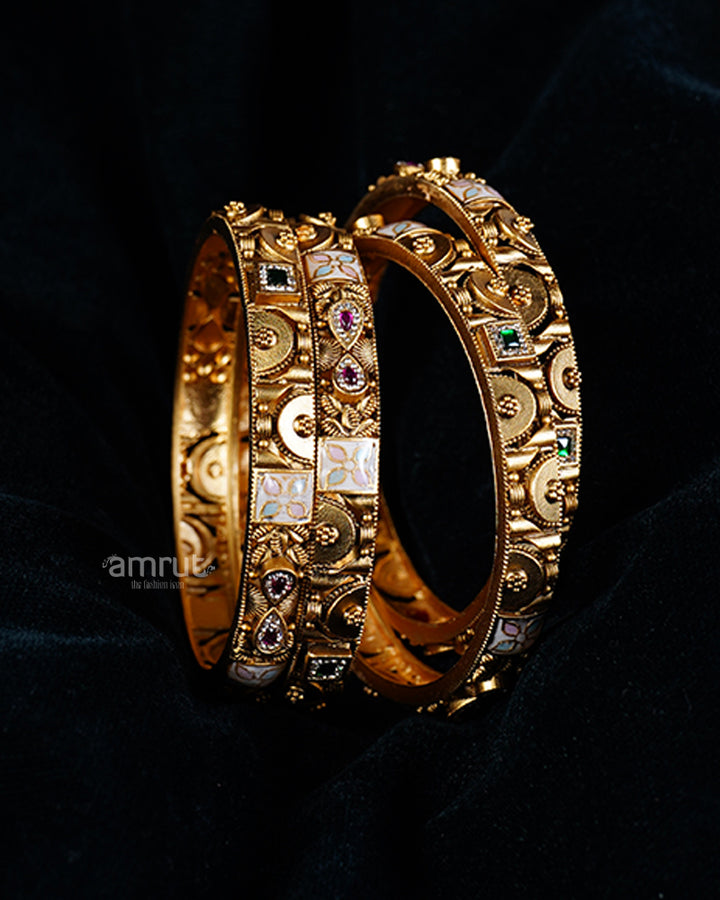 Four Gold Toned Bangles Set with Colorful Gemstones and Enamel Detailing