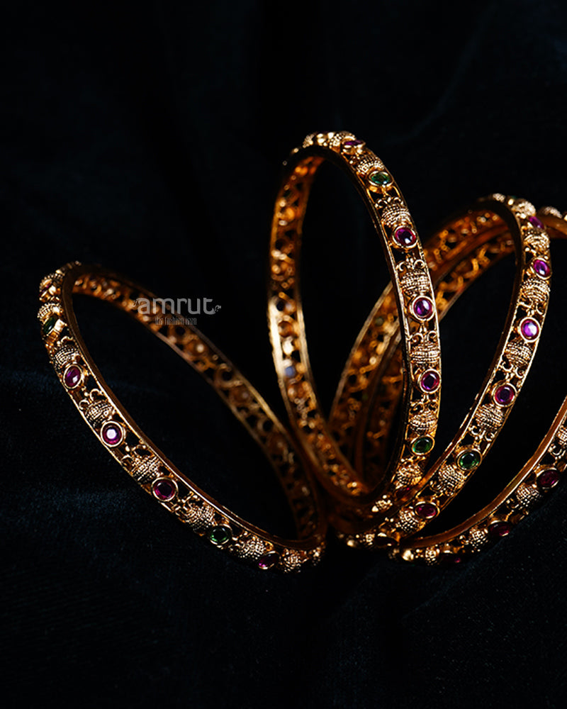 Intricately Designed Gold Bangles with Ruby and Emerald Gemstones