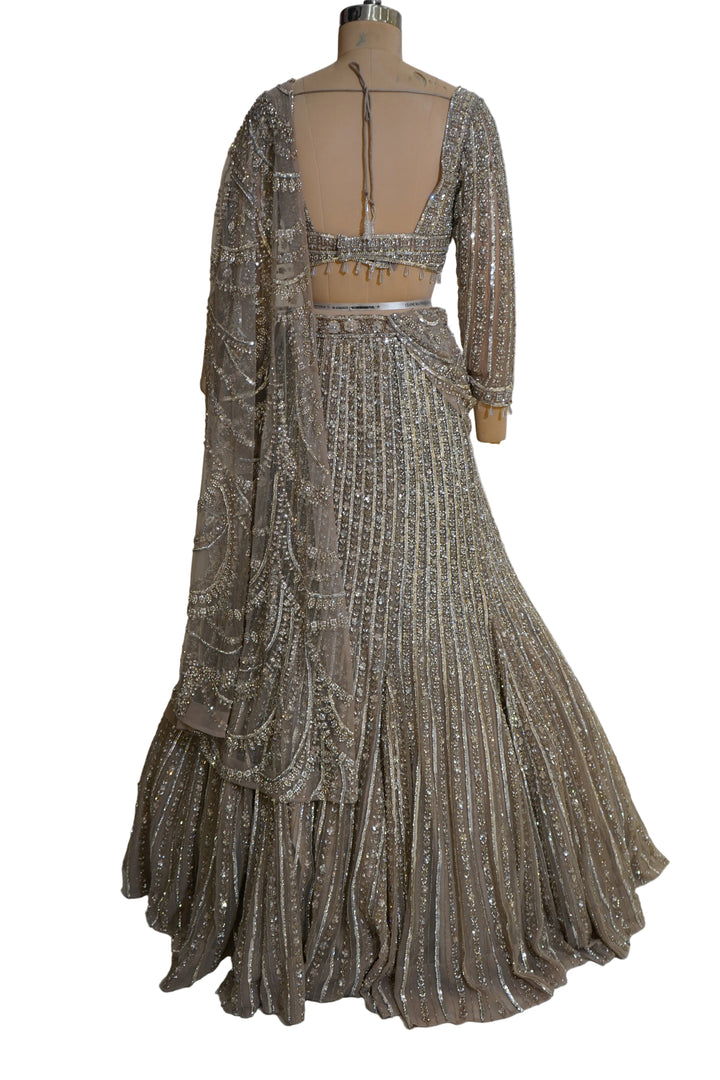 Antique Gold Mermaid Lehenga Set with Crystal Embellished Blouse and Net Dupatta