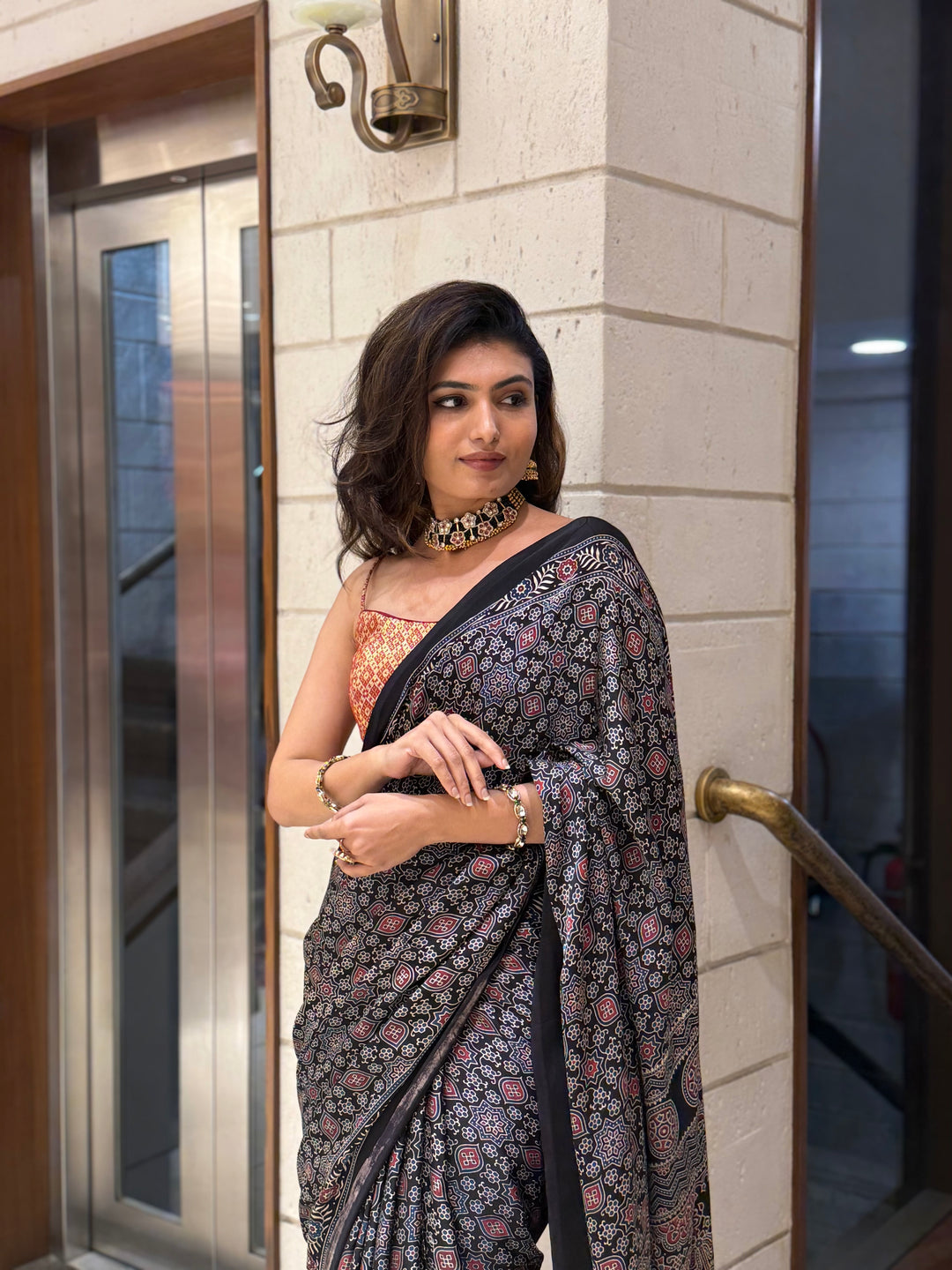 Luxury Black Ajrakh Printed Satin Silk Saree with Copper Blouse & Handcrafted Tassel Pallu