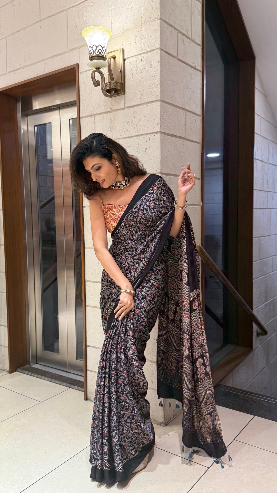 Luxury Black Ajrakh Printed Satin Silk Saree with Copper Blouse & Handcrafted Tassel Pallu