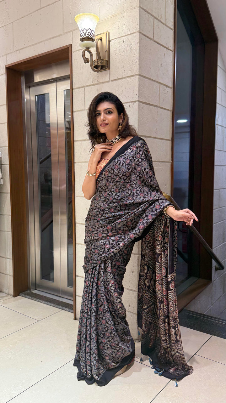 Luxury Black Ajrakh Printed Satin Silk Saree with Copper Blouse & Handcrafted Tassel Pallu