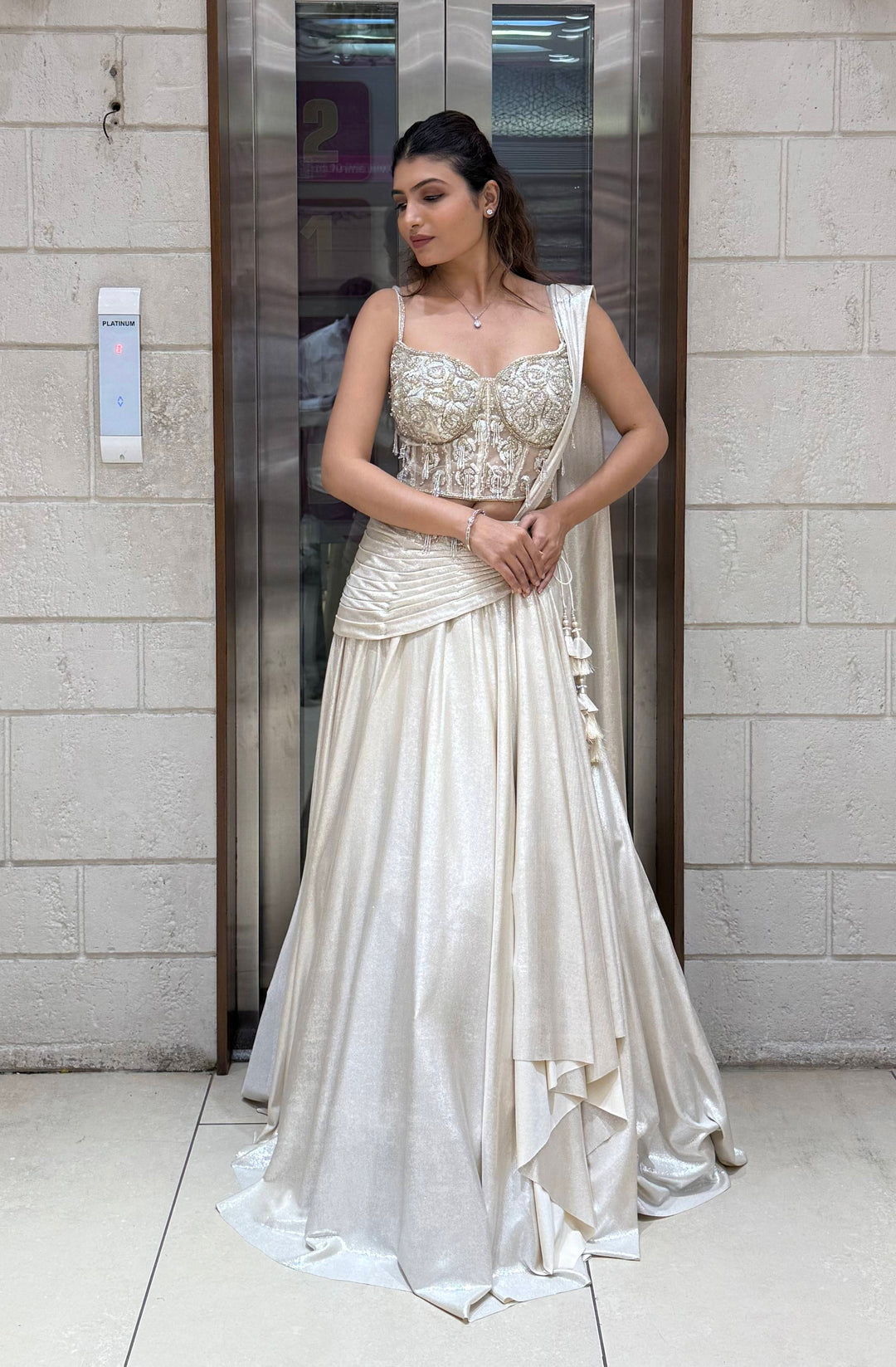 Ivory Shimmer Draped Lehenga Set with Hand-Embroidered Corset Blouse