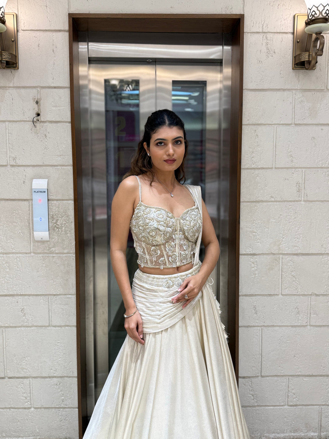 Ivory Shimmer Draped Lehenga Set with Hand-Embroidered Corset Blouse