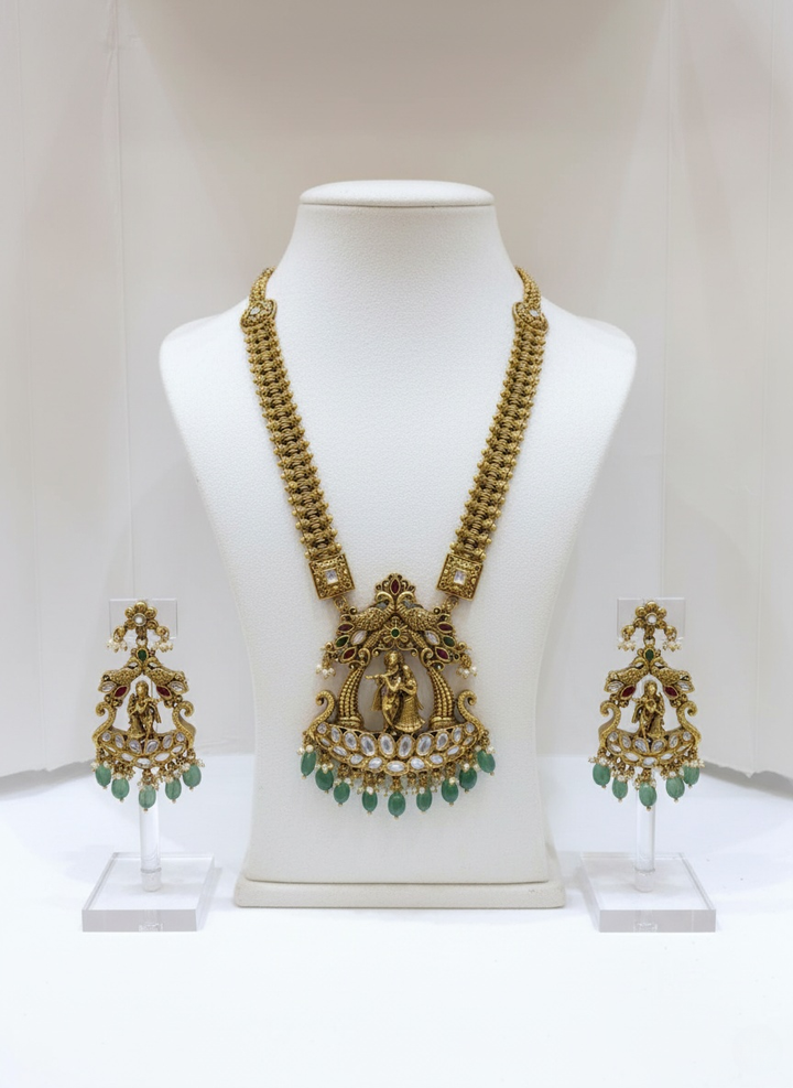 Antique Gold Necklace Set with Radha-Krishna Motif and Emerald Drops