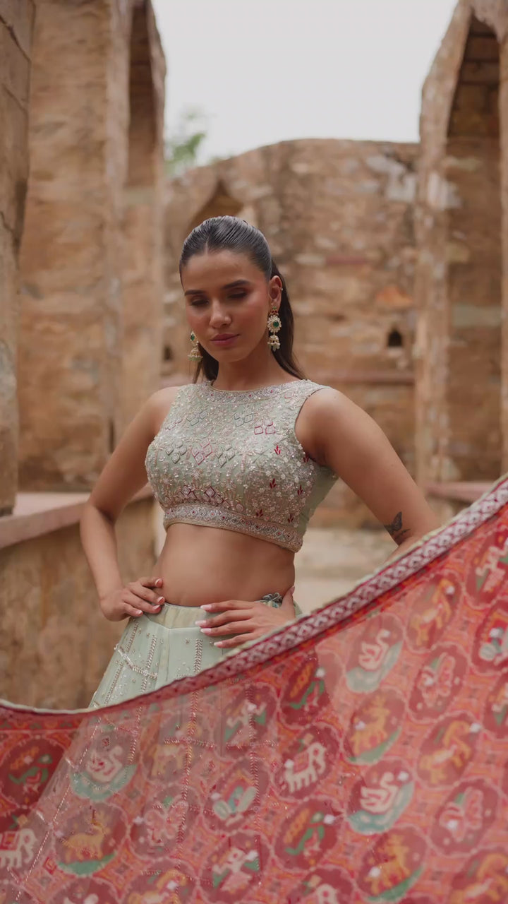Mint Green Lehenga Choli with Red Printed Dupatta and Intricate Embroidered Border