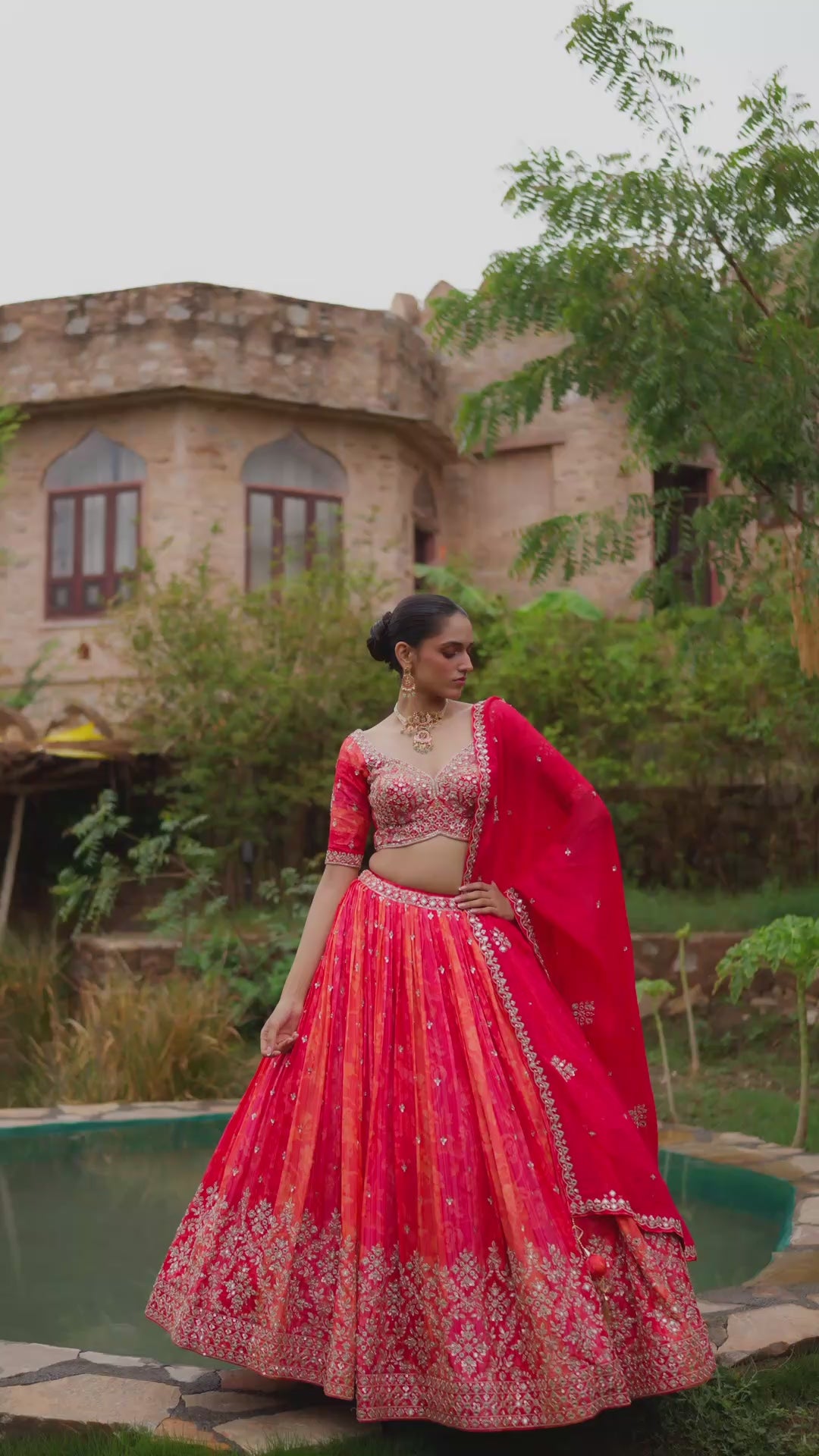 Coral Orange Bridal Lehenga Choli with Red Dupatta and Intricate Golden Embroidery