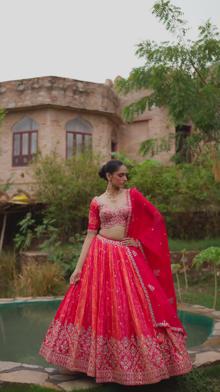 Coral Orange Bridal Lehenga Choli with Red Dupatta and Intricate Golden Embroidery