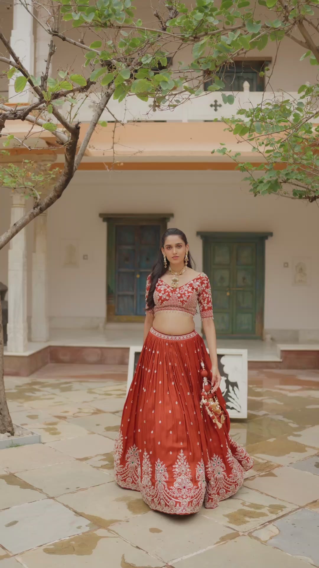 Rust Orange Lehenga Choli with Floral Embroidery and Intricate Multicolour Border