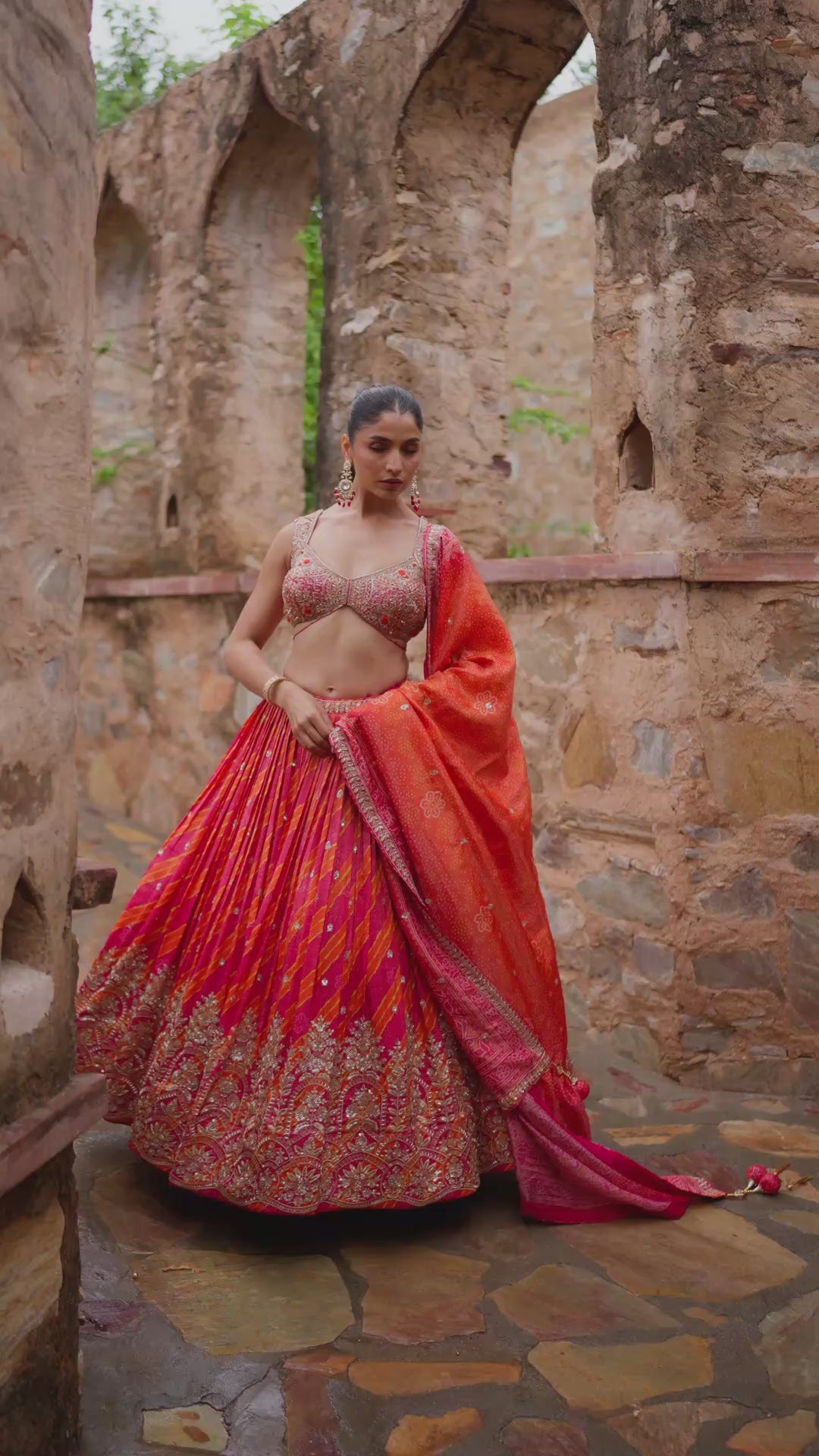 Hot Pink and Coral Lehenga Choli with Golden Embroidery and Traditional Decorative Borders