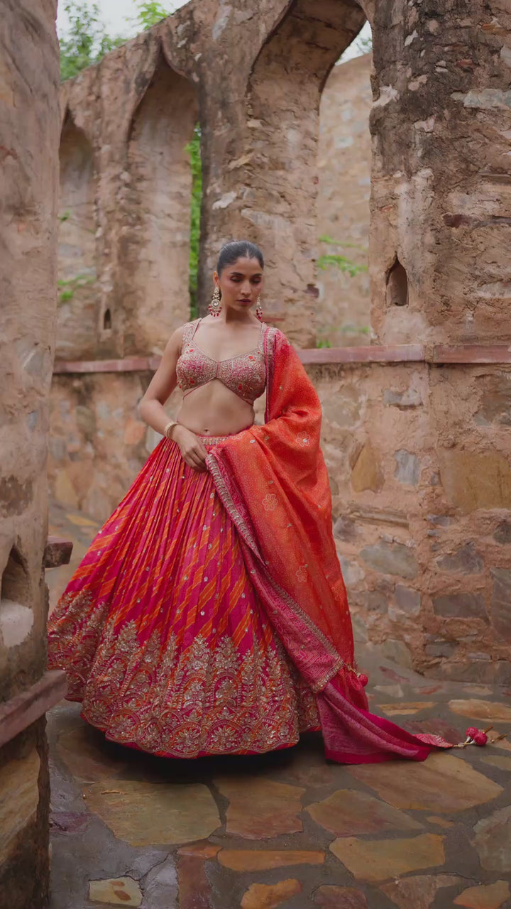 Hot Pink and Coral Lehenga Choli with Golden Embroidery and Traditional Decorative Borders