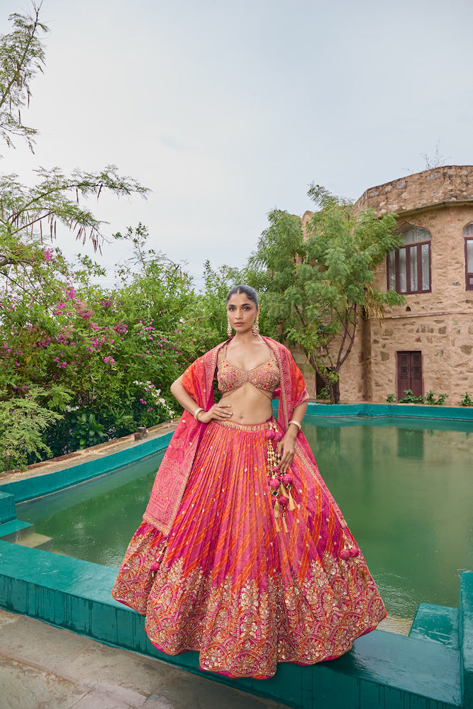 Hot Pink and Coral Lehenga Choli with Golden Embroidery and Traditional Decorative Borders