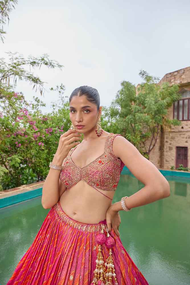 Hot Pink and Coral Lehenga Choli with Golden Embroidery and Traditional Decorative Borders