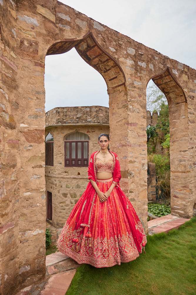 Coral Orange Bridal Lehenga Choli with Red Dupatta and Intricate Golden Embroidery