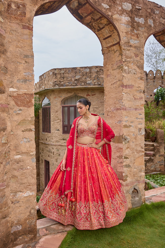 Coral Orange Bridal Lehenga Choli with Red Dupatta and Intricate Golden Embroidery