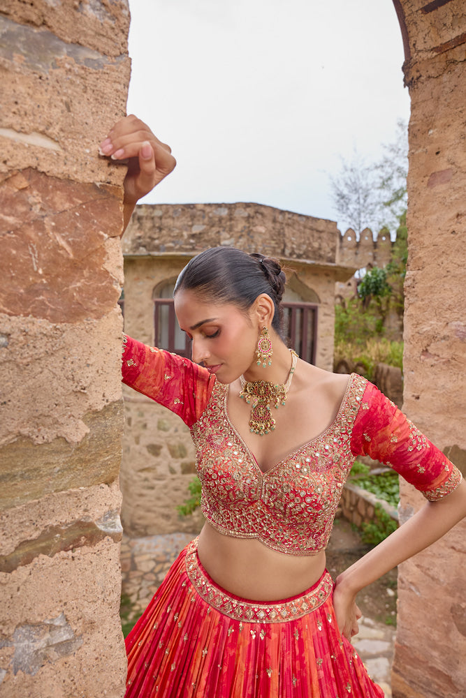 Coral Orange Bridal Lehenga Choli with Red Dupatta and Intricate Golden Embroidery