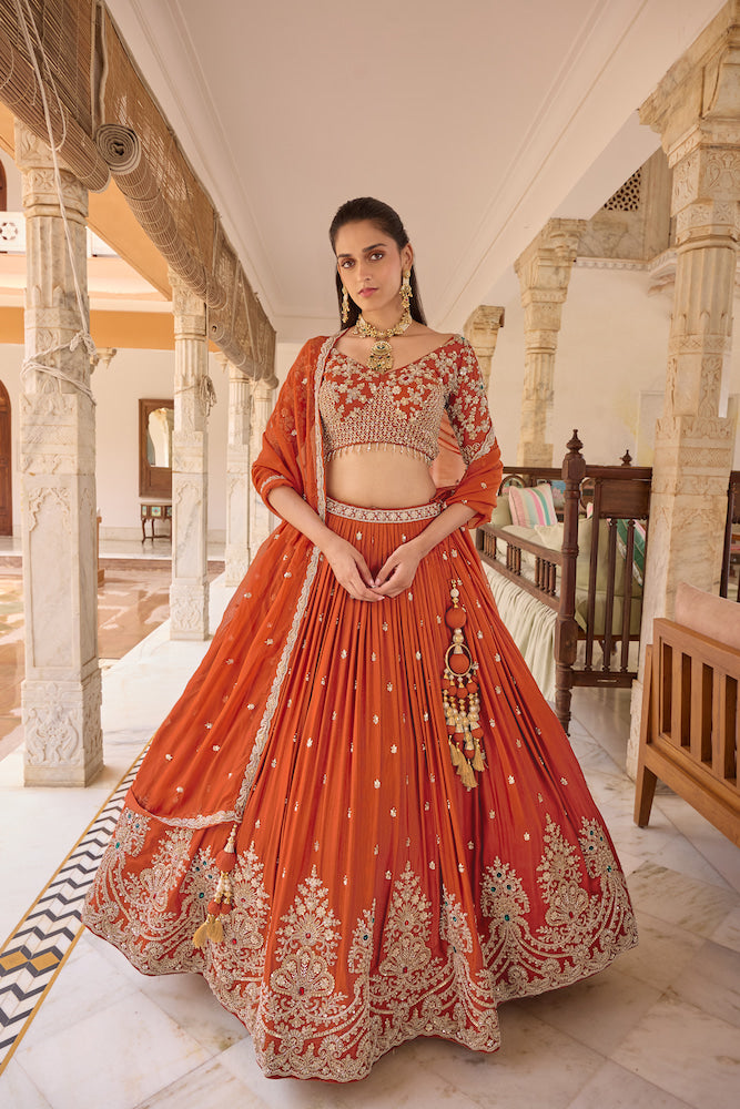 Rust Orange Lehenga Choli with Floral Embroidery and Intricate Multicolour Border