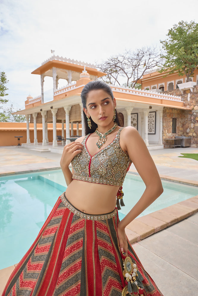 Dark Green and Red Lehenga Choli with Chevron Patterns and Golden Embroidery