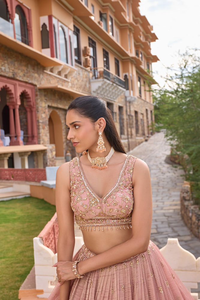 Dusty Pink Lehenga Choli with Intricate Golden Embroidery and Embellished Border